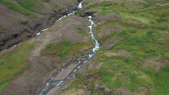 Waterfalls in Iceland that are stacked up with drone video moving over. alt