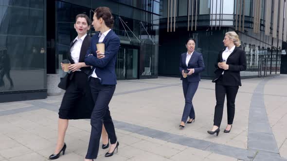 Four Caucasian Women Business Colleagues Walking Outdoors. Business Women Walking Around Corporate