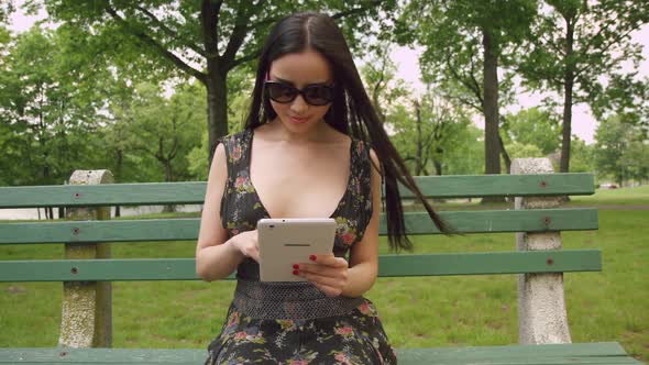 Girl Using A Tablet In The Park