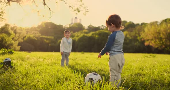 Two Cute Little Kids Playing Football Together Summertime alt