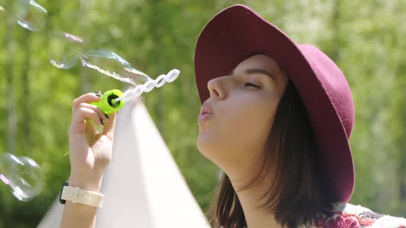 Pretty Woman Blowing Soap Bubbles alt