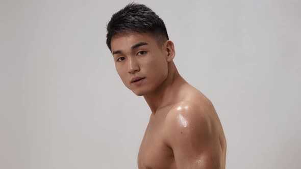 Muscular Asian Man Indoors in Th Studio alt