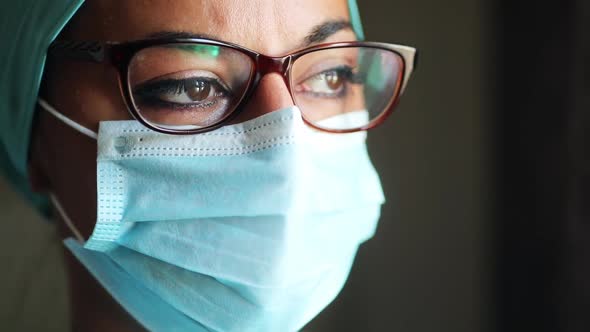 Young female medic, wearing a mask and glasses