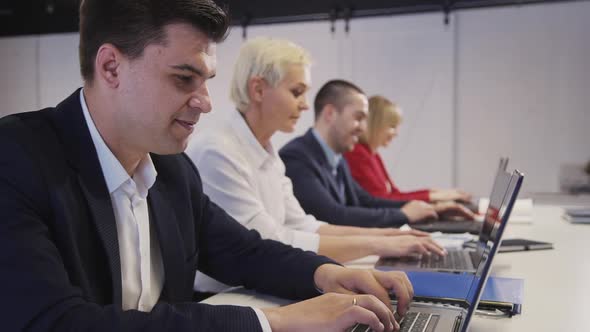Group of Woman and Man Using Laptop Computer in Office