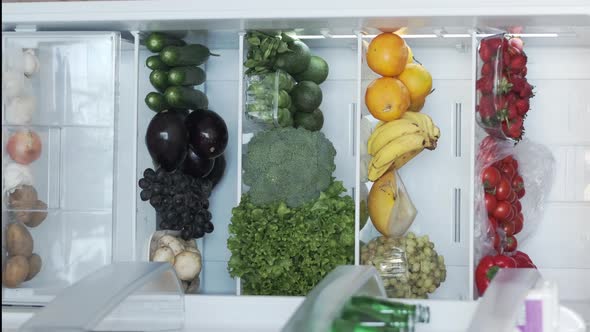 Opening a Fridge or Refrigerator in Kitchen Home CloseUp alt