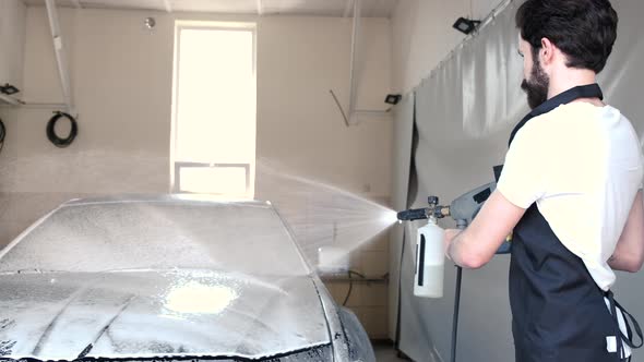 Man Washing His Car in a Garage alt