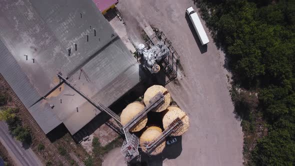 Aerial view of a flour mill with storage bins and loading areas.