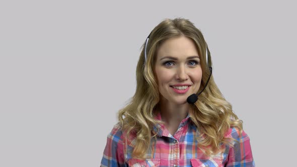 Portrait of Happy Young Woman Wearing Headset and Talking alt