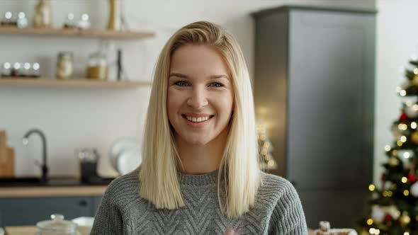 Portrait video of woman in the kitchen during Christmas.  Shot with RED helium camera in 8K. alt