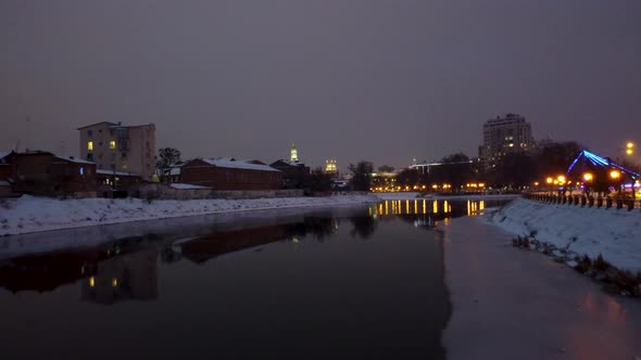 Evening illuminated Kharkiv city river aerial view