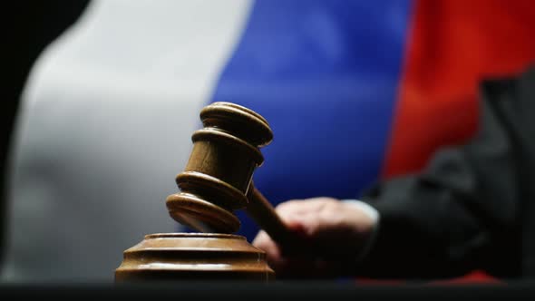 Judge With Gavel In His Hand Hammering Against Waving Russian Flag Courtroom alt