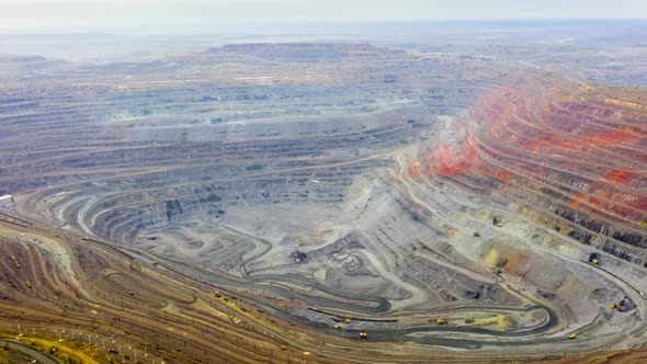 Aerial View of Opencast Mining Quarry with Lots of Machinery at Work - View From Above. alt
