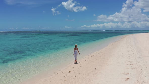 Girl Walking on a White Sand Beach on a Tropical Island in the Mauritius Indian Ocean alt