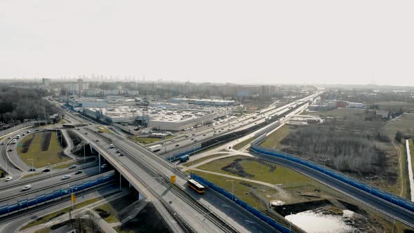 Drone View of Traffic on Contemporary Asphalt Highway with Junction Near Modern City