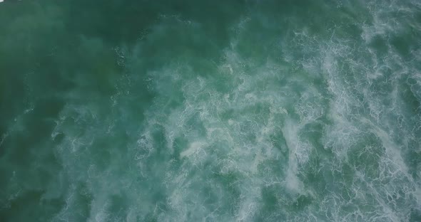 Drone Ascending Above Big Rushing Ocean Wave and Amazing Inspirational Blue and Green Seafoam alt