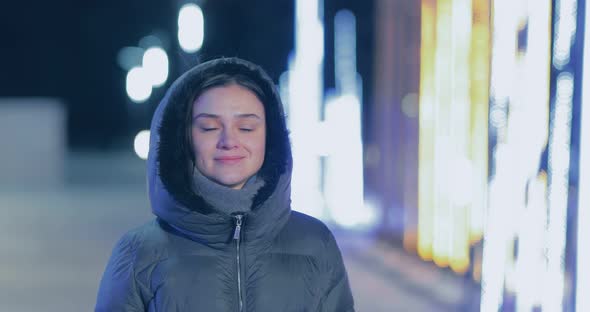 Happy Girl Walks Through the Night City in Winter the Lights are on alt