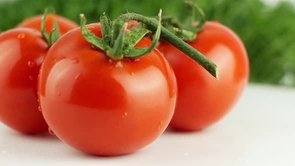 Ripe natural tomatoes close-up. Organic tomato rotating on a green background Macro shot. alt