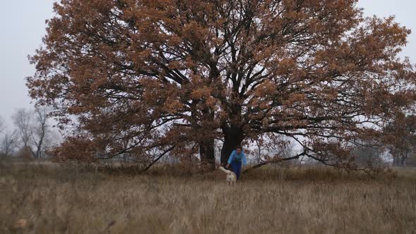 Happy Cute Dog Running To Female Owner Outdoors alt