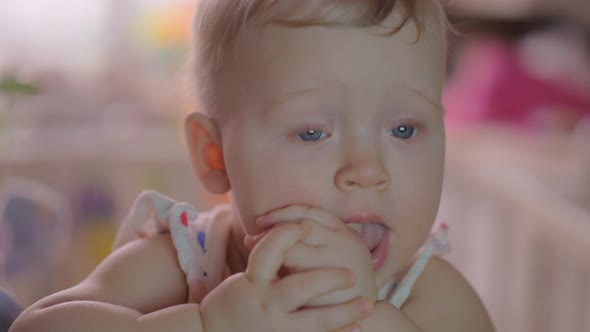 Baby Girl in a Round Crib alt