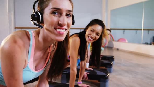 Group of women exercising in the fitness studio alt