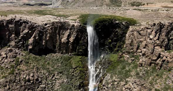 Aerial view of a crane shot of the inverted waterfall with a rainbow appearing all along its path on alt