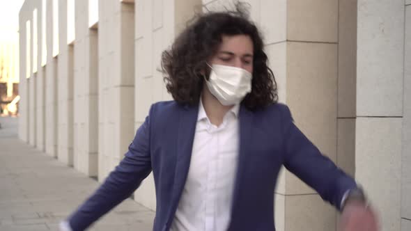 Happy Businessman Dancing in a Medical Mask alt