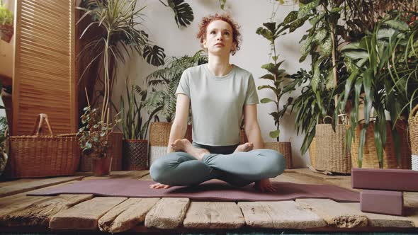 Woman Performing Scale Pose during Home Yoga Training alt