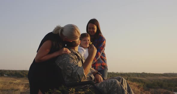 Wife Hugging Wheelchaired Husband alt