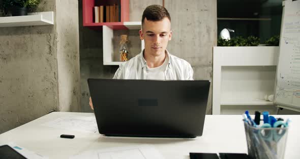 Man Working on Laptop in Office