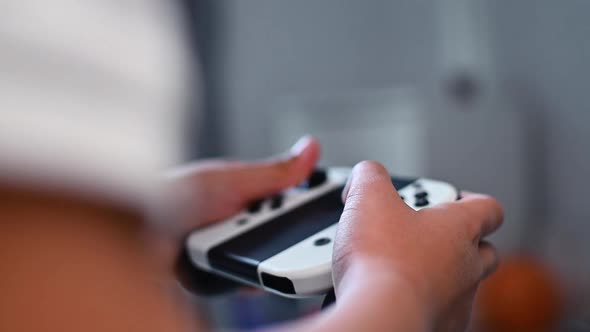 Boy playing video game using modern joystick,close up video