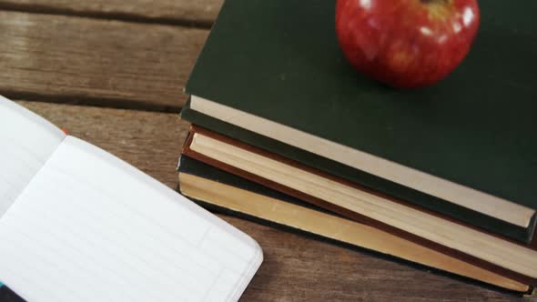 Apple on book stack alt