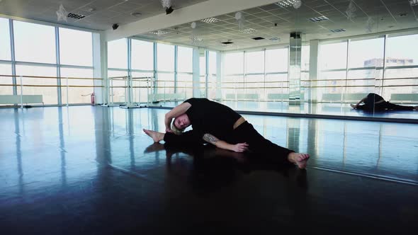 Ballet Dancer in Sportswear Doing Stretching Exercises to Keep Fit