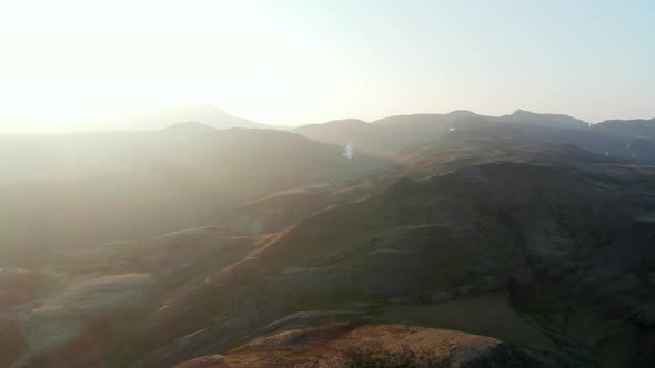 Backlight Amazing Aerial View of Iceland Countryside with Steaming Fumaroles alt