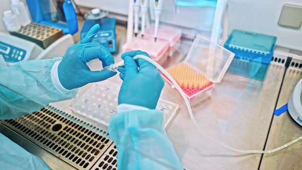 Technician with Tube of Blood Sample alt