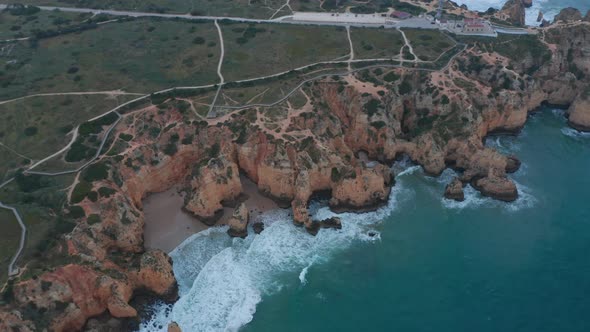 Establishing Aerial Drone View of Scenic Outdoor Coastline in Lagos Portugal Circling Pan Above alt