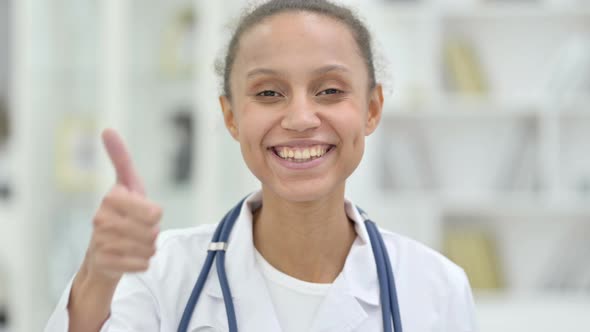 Portrait of Young African Doctor Showing Thumbs Up Sign  alt