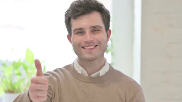 Portrait of Man Showing Thumbs Up Sign alt