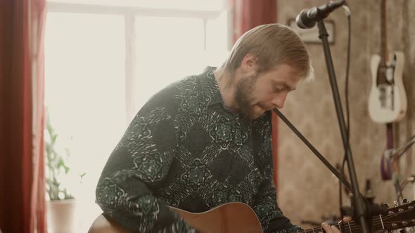 Adult Musician Playing Guitar at Home