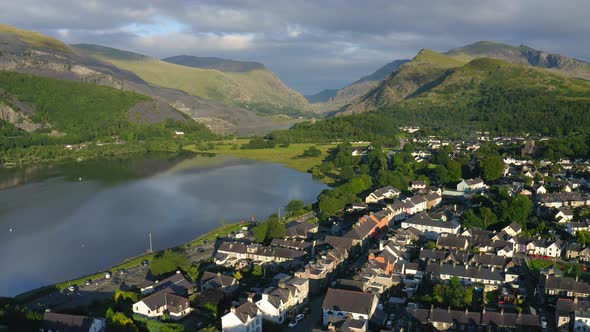 European Village near Mountain Lake Snowdonia in Wales - Aerial Drone Landscape alt