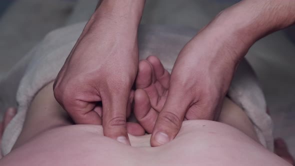 Cropped View of Masseur Massaging Man's Back in Spa alt