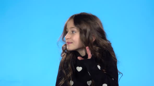 Girl Is Telling a Secret Covering Her Mouth with Palm alt