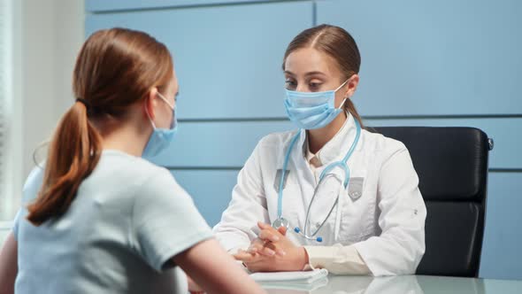 Young woman general practitioner in blue disposable face mask alt
