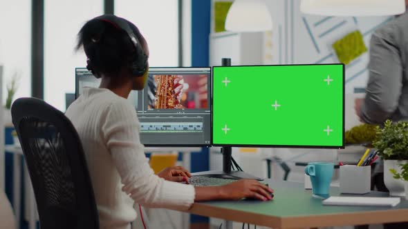 African Woman Videographer with Headset Processing Film Montage alt