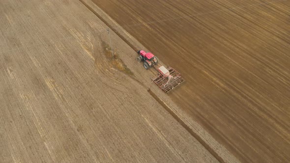 Tractor Passes Under Power Line alt