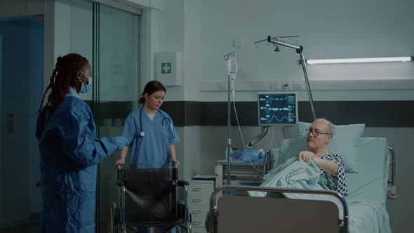 Sick Patient Sitting in Wheelchair in Hospital Ward at Clinic alt