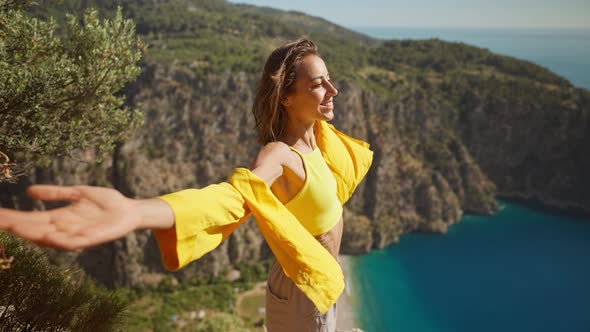 Side View Happy Traveler Freedom Filling Woman with Open Arms Laughing and Enjoying Mountains View alt