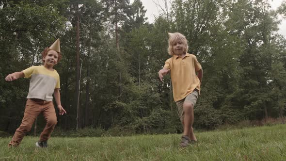 Five-year-old Boys Dancing in Park alt