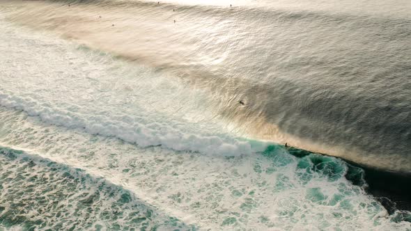 Following large waves at sunset