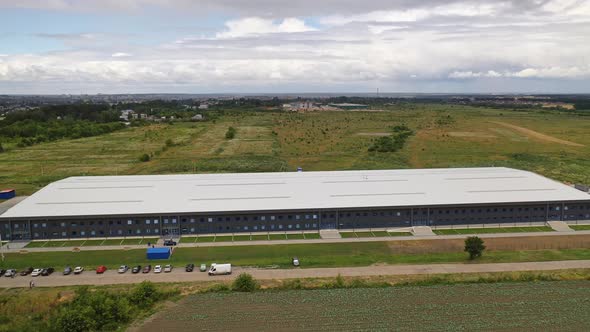 Modern distribution center from above. Aerial view of warehouse storage of industrial factory alt