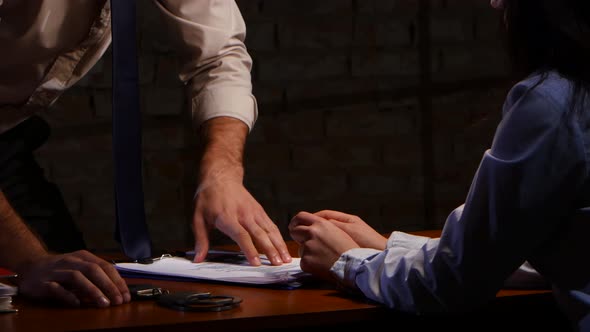 Woman Reluctantly Writes Confession of Crime on Sheet of Paper alt